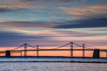 dramatic spring sunrise in Maryland with the Chesapeake Bay and Key Bridge on the background.