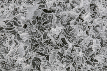 Top view ice abstract pattern of frozen Lake Baikal on cloudy winter day