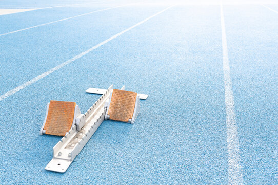 High angle of starting blocks placed on blue track at stadium before race