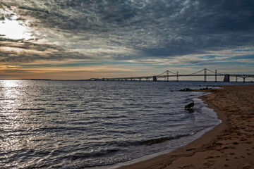dramatic spring sunrise in Maryland with the Chesapeake Bay and Key Bridge on the background.