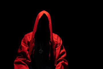 Mystic red hooded person in the darkness. Pentagram pendant on the chest. Satanic ,occult, esoteric and black magic concept. Copy space.
 - obrazy, fototapety, plakaty