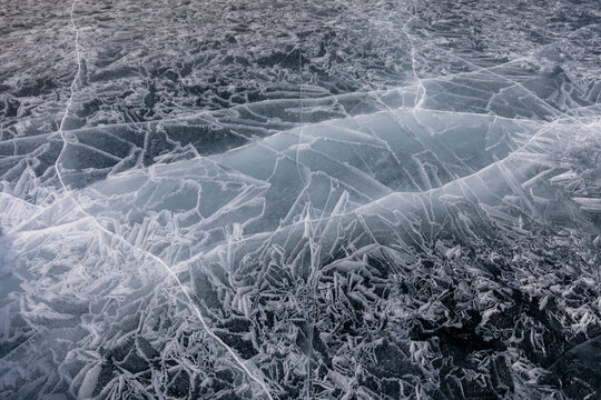 Top view ice abstract pattern of frozen Lake Baikal on cloudy winter day