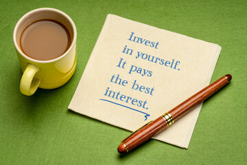  Invest in yourself. It pays the best interest. Motivational advice or reminder - handwriting on a napkin with cup of coffee. Lifestyle and personal development concept.