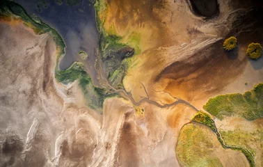 Foto op Plexiglas Dry lake or swamp in the process of drought and lack of rain or moisture, a global natural disaster - aerial drone view © bereta