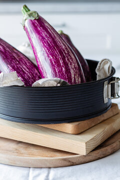 Fresh eggplants placed on table for cooking healthy vegetarian lunch at home