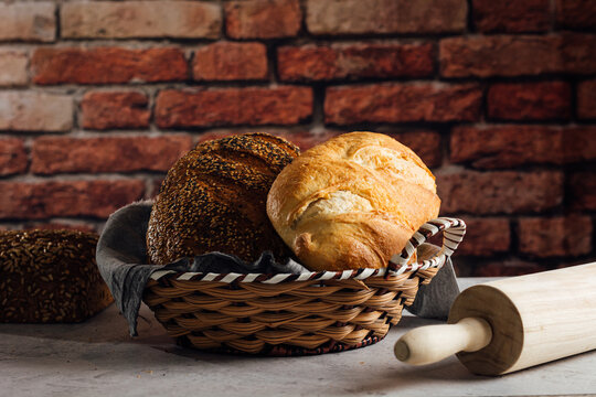 Delicious wholegrain bread in straw basket on table