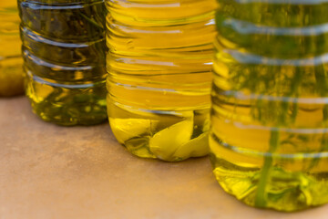 close-up of cold-pressed golden olive oils in various aromatic flavors with mediterranean herbs and...