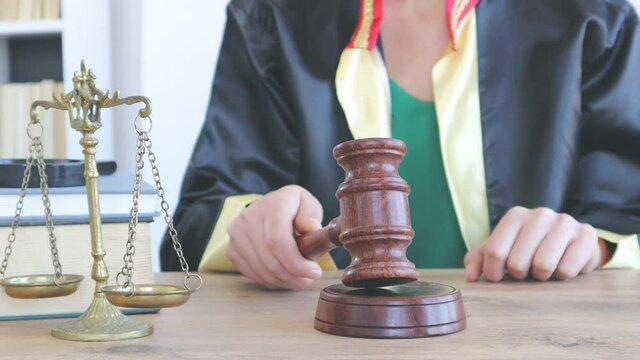 Woman lawyer working with contract papers and wooden gavel on tabel in courtroom. justice and law ,attorney, court judge, concept.