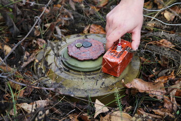 Russian anti-tank mine TM-62M with a TNT block installed on it, necessary for the clearance of mines during detonation. The inscription in russian on the photo: "TNT block 400 grams with M10x1 thread"