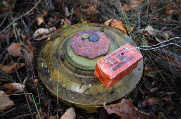 Russian anti-tank mine TM-62M with a TNT block installed on it, necessary for the clearance of mines during detonation. The inscription in russian on the photo: "TNT block 400 grams with M10x1 thread"