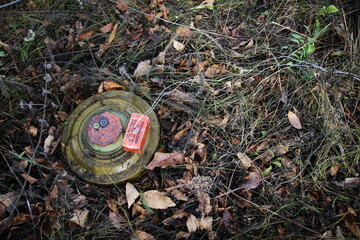 Russian anti-tank mine TM-62M with a TNT block installed on it, necessary for the clearance of mines during detonation. The inscription in russian on the photo: "TNT block 400 grams with M10x1 thread"