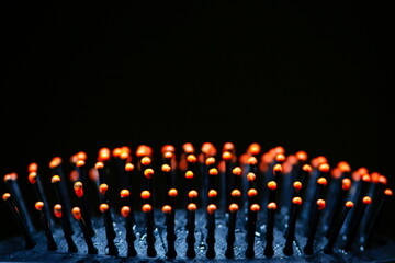 Orange tips of chopsticks on black background