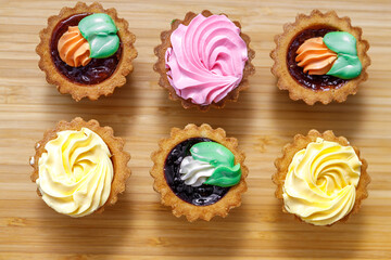 Shortbread cake with colorful creams. Cake basket.