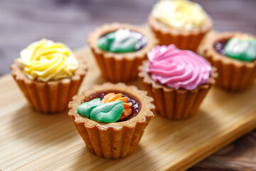 Shortbread cake with colorful creams. Cake basket.
