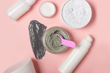 An open cosmetic jar, against the background of a smeared cream or cosmetic face mask. Purifying...