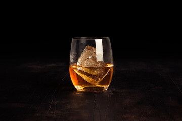 Closeup of a glass of tea with an ice cube