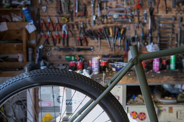 Set of different iron instruments for repairing on lumber wall in modern workshop