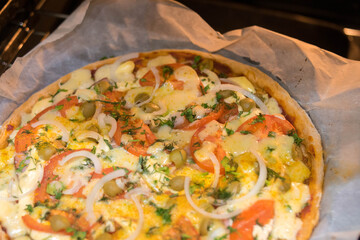 Homemade pizza. Pizza in the oven. Family evening. Homemade baking. Bake. Pizza. Leisure at home. Cooking. Recipes.