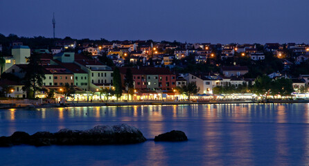 Fototapeta na wymiar night view of the town and sea / Njivice, Croatia