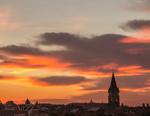 dramatic sunrise on the church steeple and   rooftops of Baltimore City in Maryland