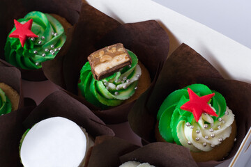 cupcakes with cream and red stars on a white background