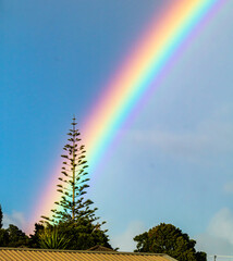 Rainbow over the town. Ranui, Auckland, New Zealand