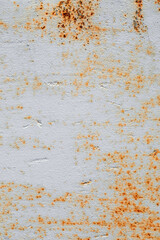 Painted old grunge textured metal sheet surface with traces of heavy rust. Top view, vertical orientation. Flat lay