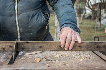 Carpenter's Hands Cutting Wood With Tablesaw