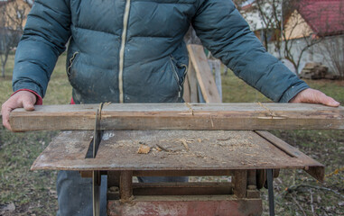 Carpenter's Hands Cutting Wood With Tablesaw