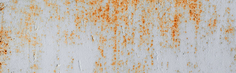 Painted old grunge textured metal sheet surface with traces of strong and heavy rust. Background panoramic banner. Top view. Flat lay