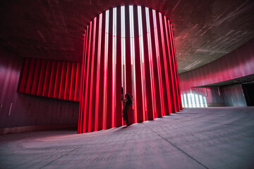 Side view of anonymous female theater artist stretching leg while preparing for performance on stage in daytime