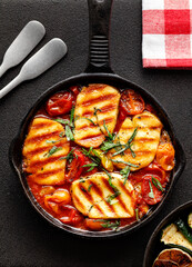 Grilled halloumi cheese and tomato bake. Vegetarian Healthy and vegetarian food. 