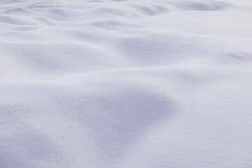 Textured backdrop of snowy terrain with white bumpy surface in winter season in daylight