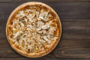 Fresh pizza with, black olives, mozzarella cheese, ham on wooden table closeup. Space for text or copy space. Pizza menu. Restaurant menu advertise