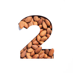 Number two made of almonds and paper cut in shape of second numeral isolated on white. Typeface of...
