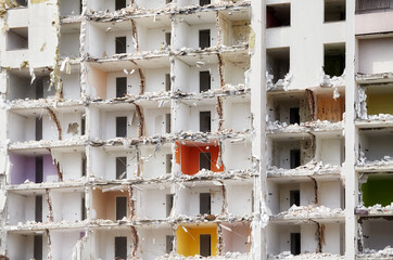 Destroyed apartment building without a front wall.