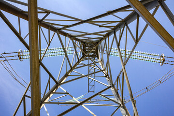 An electric power line support pole on a mountain top in the open air on a sunny summer day