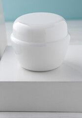 White cream lotion container on blank white box