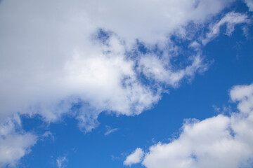 white clouds against a blue March sky, sunny day