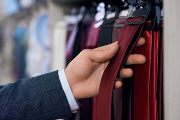 Process choosing maroon tie in store.