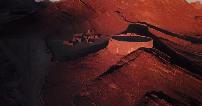 Long Shot Aerial Earth to Sky View When Landing and Move Down - Ruins of an Old Ancient Cemetery in the Mountain Near Yazd in Iran Desert Area