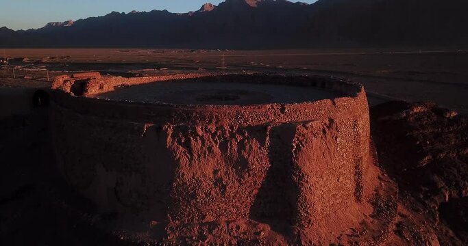 Aerial Shot from Dakhmeh the Place for Death Bodies under the Sun in Ancient History in Yazd in Iran - An Old Round Architecture Design by Mudbrick and Adobe Revealed Vastness of Structure in Sunset