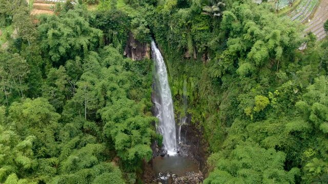 Spectacular Curug Silawe waterfall in tropical jungle in Magelang, Indonesia