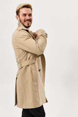 man fashion hairstyle beige coat studio light background