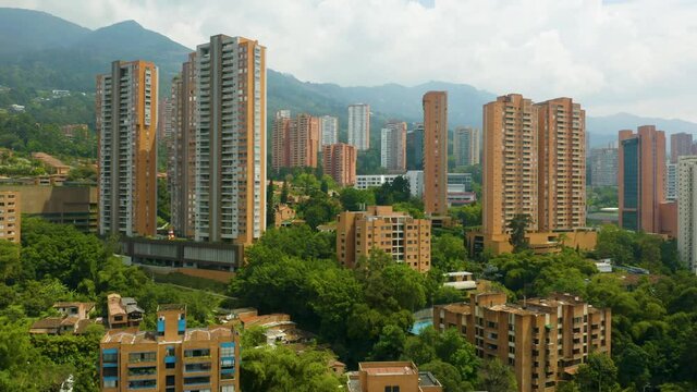 Drone Elevates to Reveal El Poblado Neighborhood on Cloudy Day in Medellin, Colombia