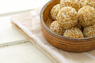 Vegan protein dessert, raw oatmeal nuts, fruit pieces, dried fruit, honey, coconut on a light background. Selective focus, place for text. natural healthy breakfast