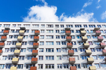 Bialystok city in Poland architecture background. High block of flats skyscraper living area. Old neighborhood retro style. Metal sheet cladding. Sunny balcony apartments.