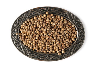 Coriander seeds in embroidered, embossed silverware pot, bowl isolated on white background, top view