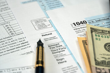 Refund of tax, filling Form 1040 U.S. Individual Income Tax. Tax Payment Concept. Selective focus