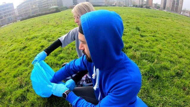 young volunteers clean the city park on a sunny day
